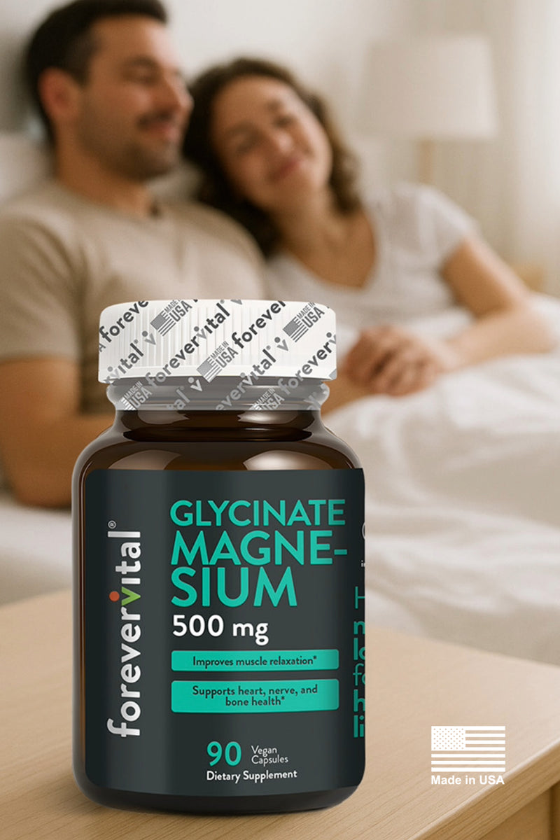 Lifestyle image of a couple relaxing in bed with Forevervital Magnesium Glycinate 500mg bottle in the foreground, made in the USA.
